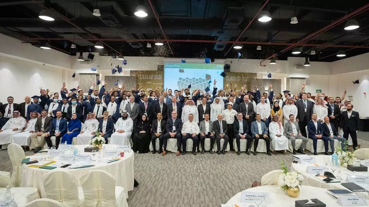 Saudi Arabia Drilling Academy graduates pose with sponsors and academy leadership at their graduation in Abqaiq