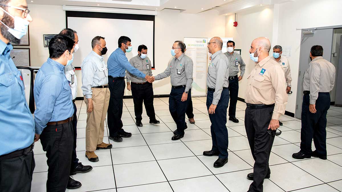 Aramco CEO Amin Nasser shakes hands at Safaniyah