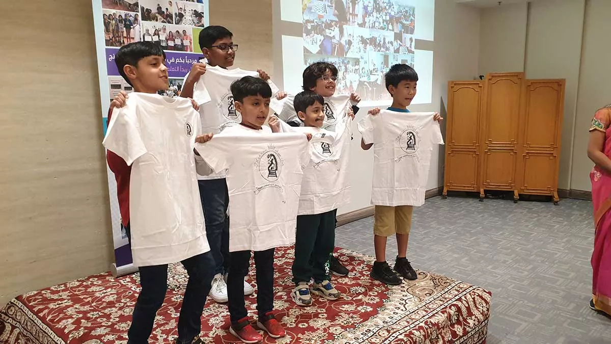 Dhahran Chess Group annual meeting and event 50th anniversary young chess players with new logo