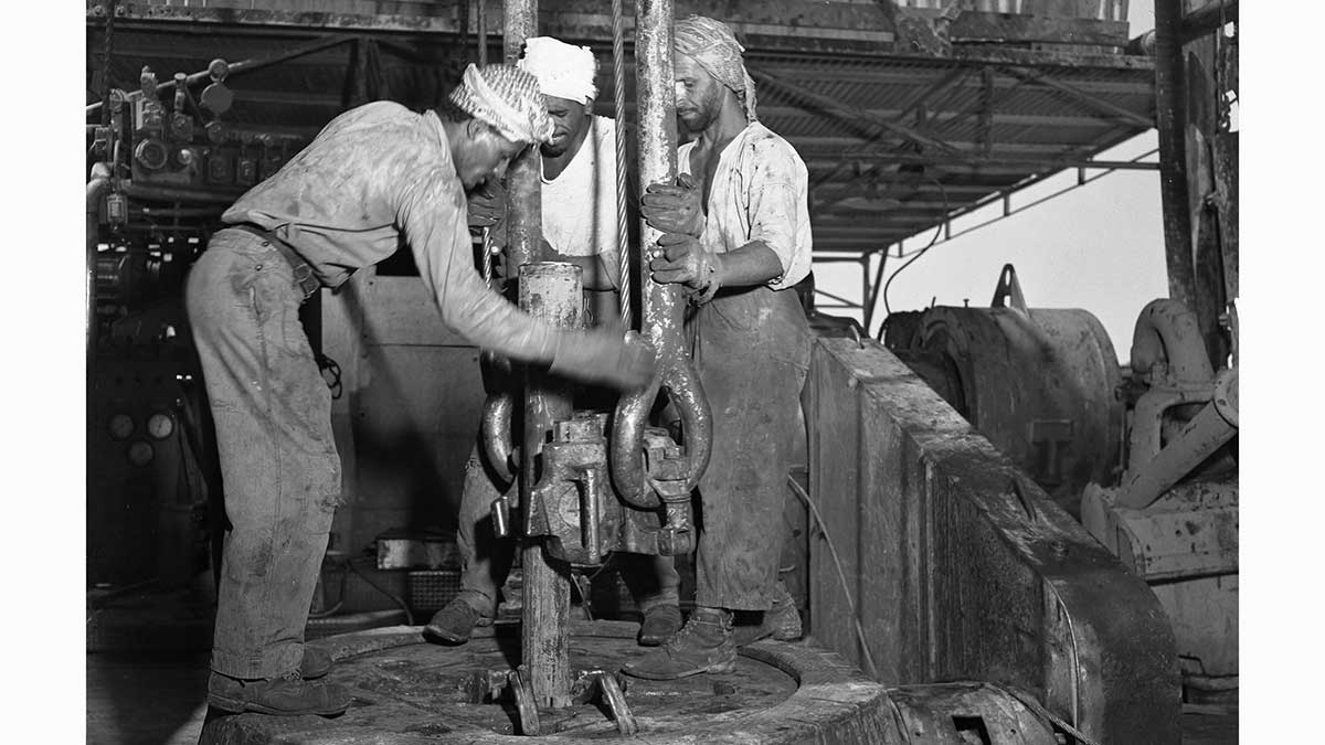 Saudi employees work the Abqaiq wellhead