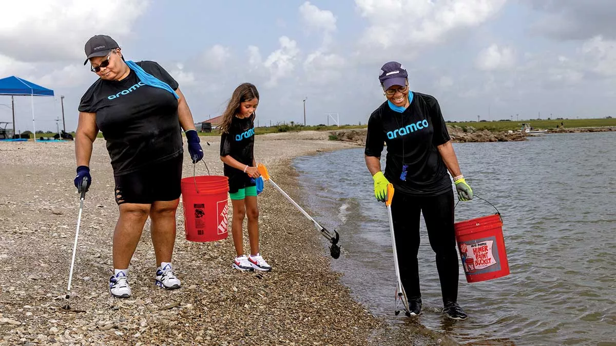 Texas City Galveston Bay cleanup Aramco volunteers on the shoreline