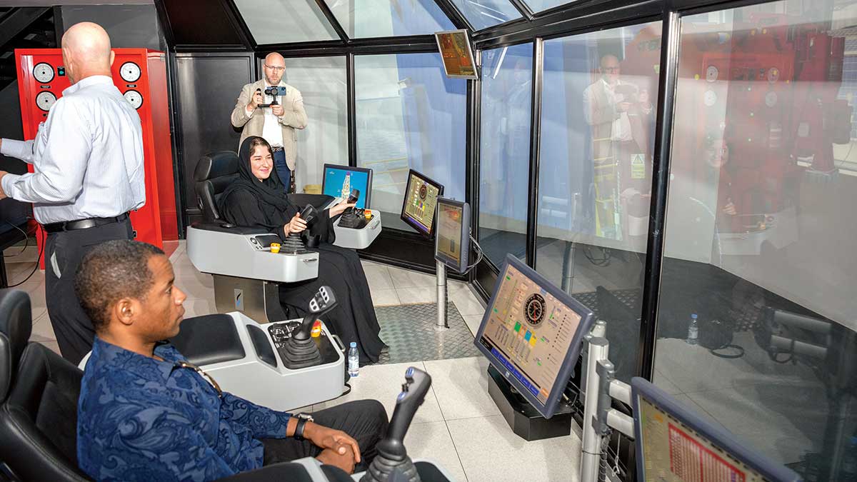 Students studying in the U.S. try out Aramco's drilling simulator