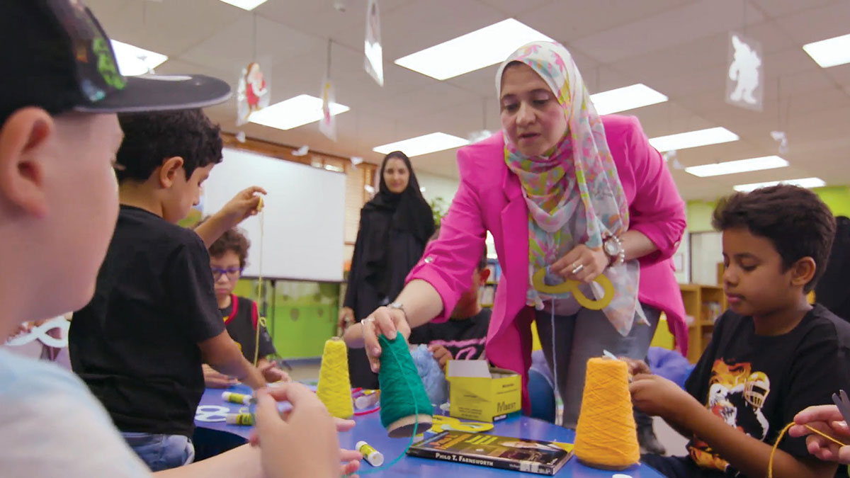 Amira the Storyteller shares a moment with youngsters in Dhahran