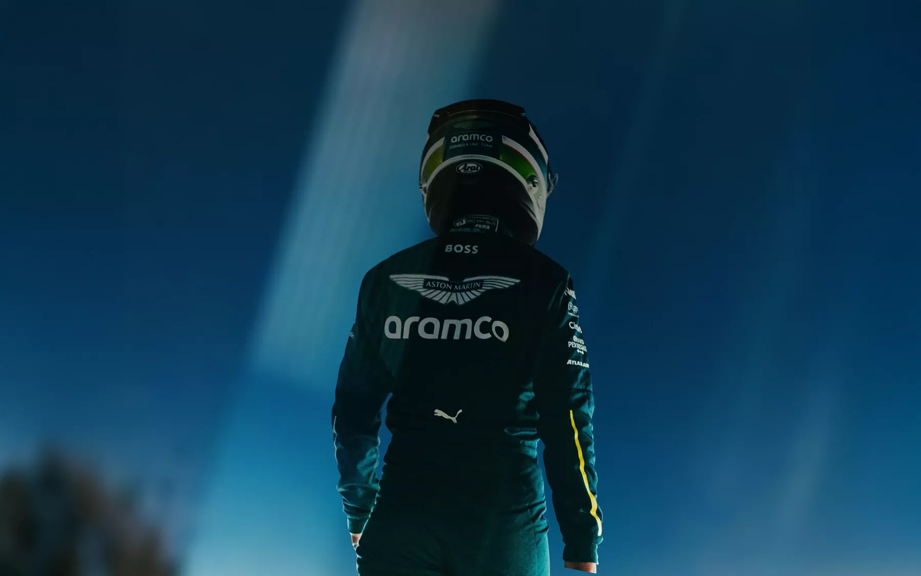 Aston Martin Aramco car driver standing with the back turned to the camera
